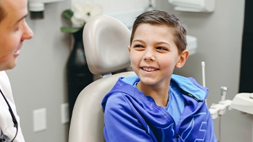Little boy smiling at dentist during children's dentistry visit