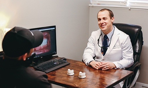 Dentist smiling at patient during dnetal veneer consultation