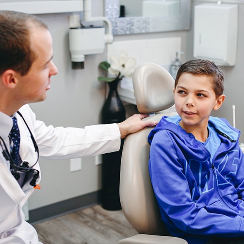 Young boy talking to Doctor Cline during children's dentistry visit