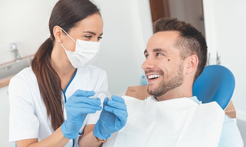 Man talking with his dentist about ClearCorrect in Idaho Falls