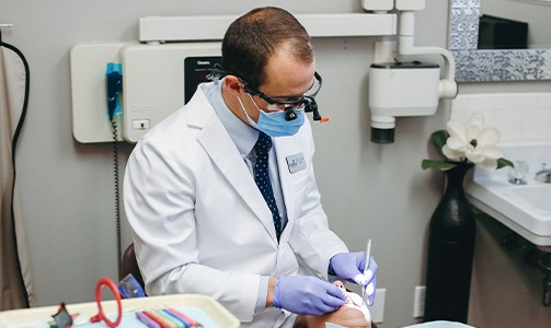Dentist placing dental crown restoration