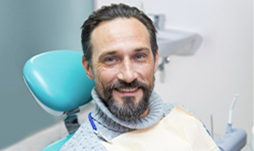 Dentist discussing replacing missing teeth with dental patient