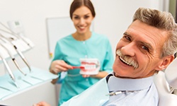 An older man consulting a dentist about dentures