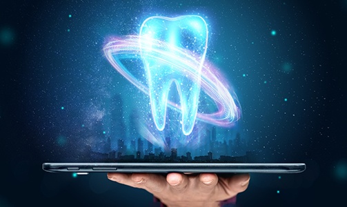 Model of tooth displayed above tablet, illustrating dental implant technology