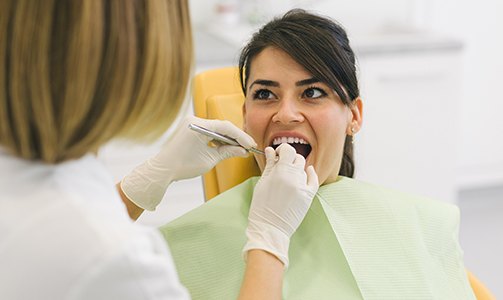 Dentist providing preventive dentistry to patient