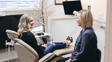 Patient smiling at dental team member during preventive dentistry appointment